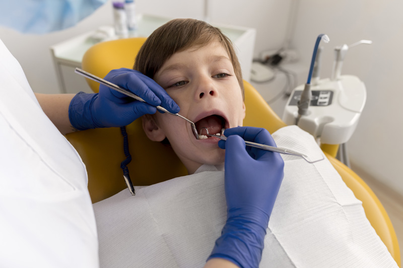 dentist cleaning child s teeth